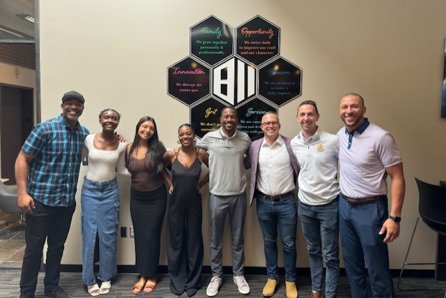 (2023): Nate and members of Eight Eleven’s Denver office post with leadership from Athletics and Beyond, a Denver-based nonprofit and Quarterly Impact recipient.